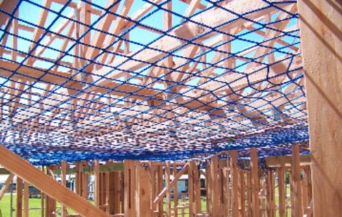 Construction safety nets installed under scaffolding